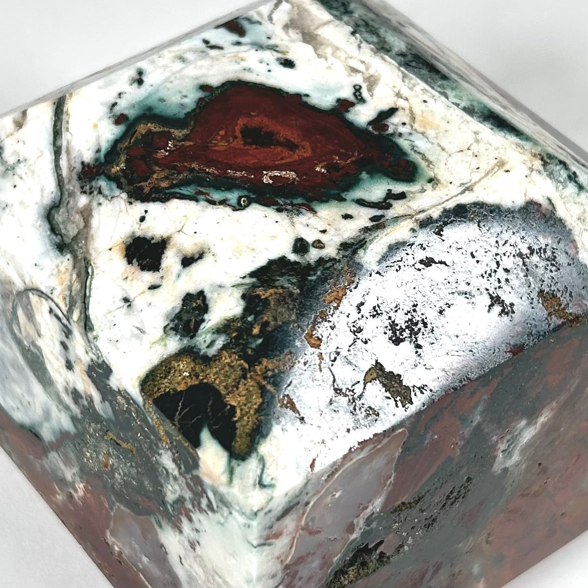Ocean Jasper Faceted Cube Paperweight in Oxblood, White, and Green
