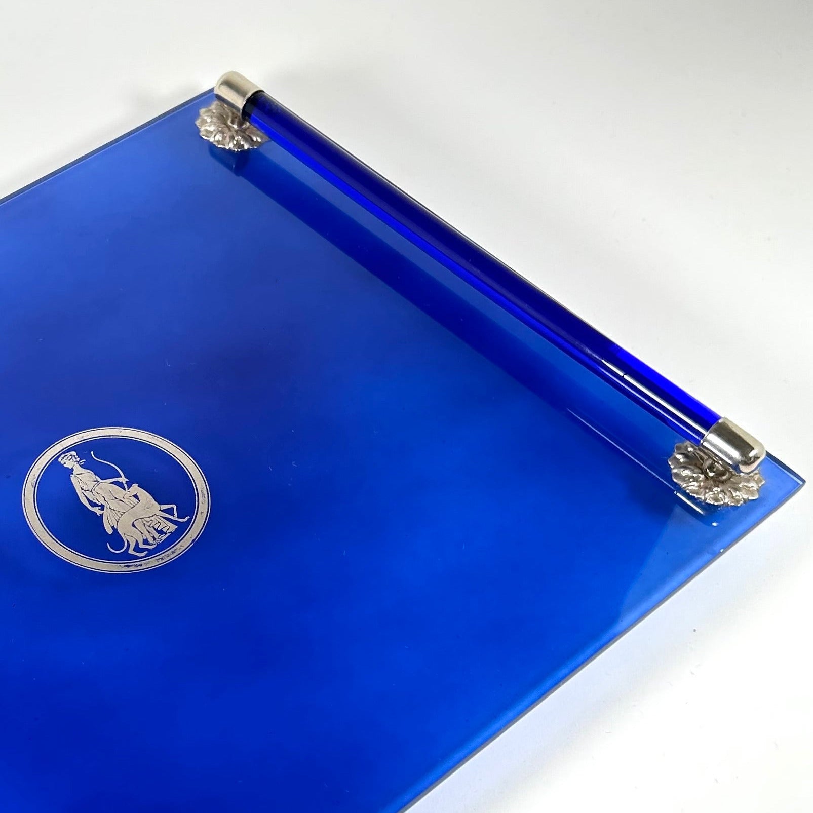Blue tray with silver accents on a white background