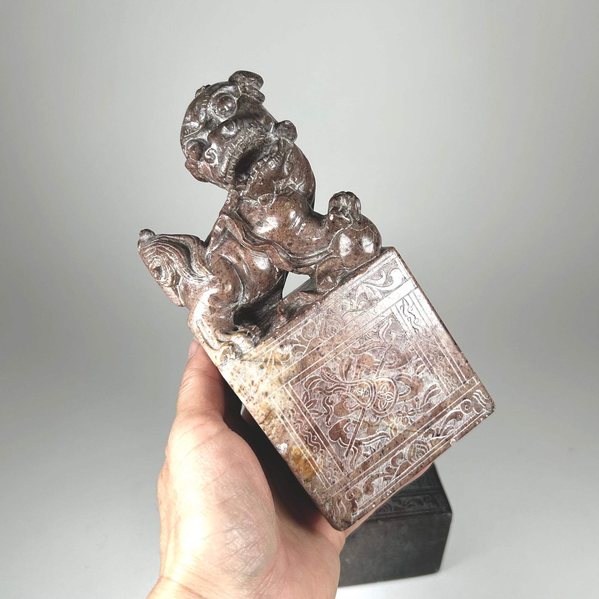 Small Hardstone Foo Dog Pair on Plinths - Carved with Floral Design - Red / Grey Stone