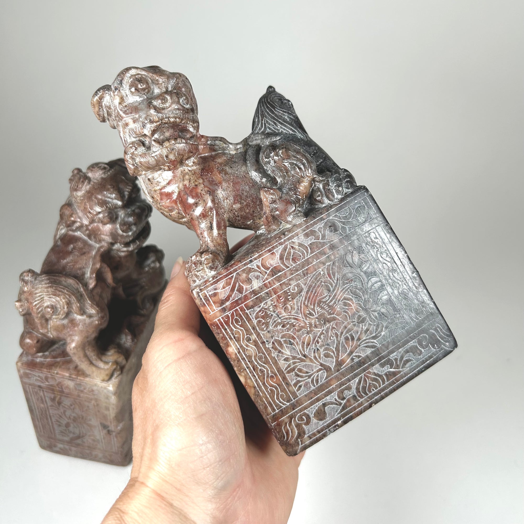 Small Hardstone Foo Dog Pair on Plinths - Carved with Floral Design - Red / Grey Stone